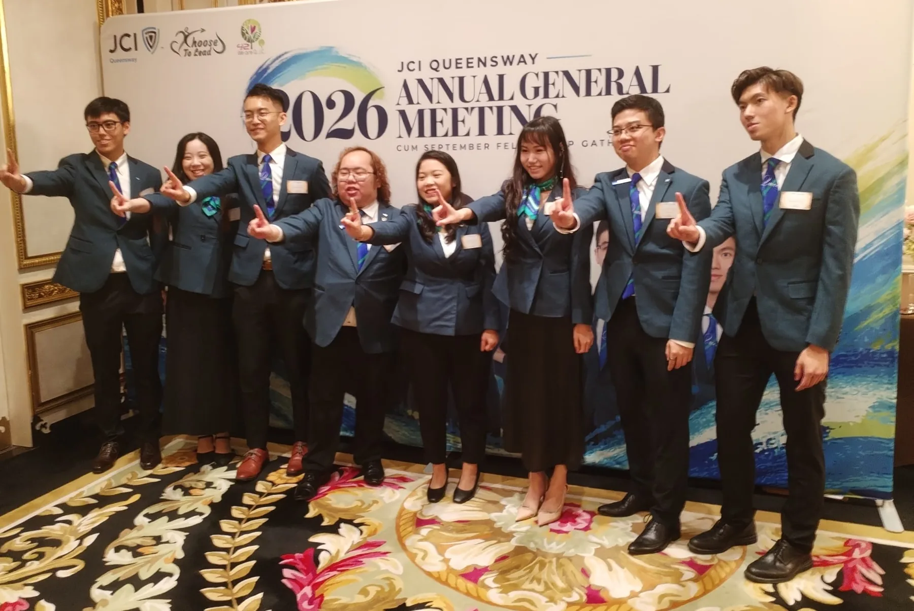 Eight members at the 2026 AGM backdrop