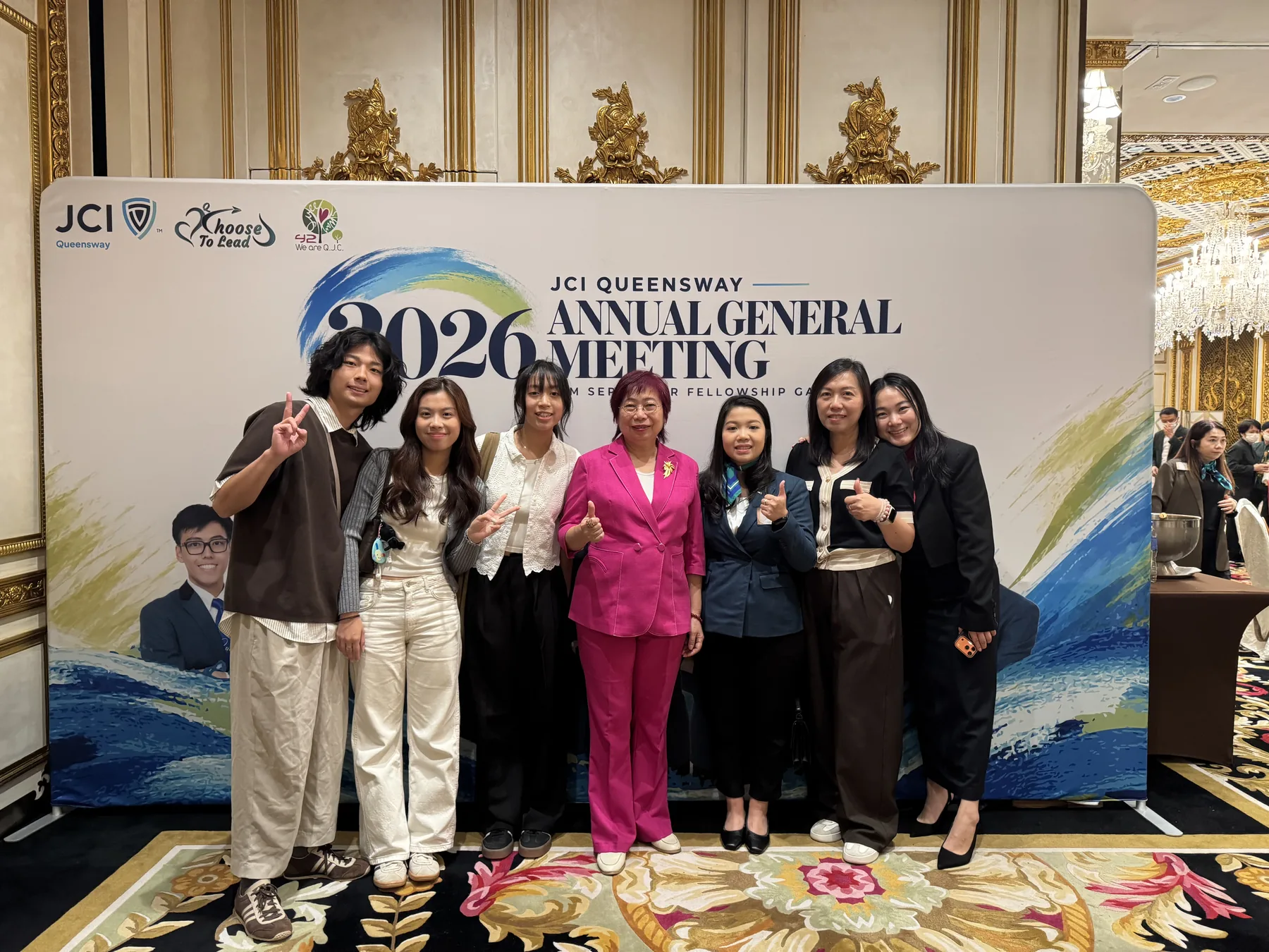 Members in front of the 2026 AGM backdrop.